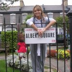 Bearsac and Kara Tointon by Albert Square sign