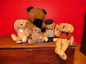 Group of teddies, some with powerful raised arms