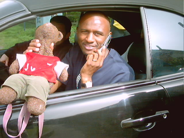 Ex Arsenal footballer Patrick Vieira holding Bearsac in his car window.