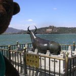 Bearsa beside brass bull beside lake