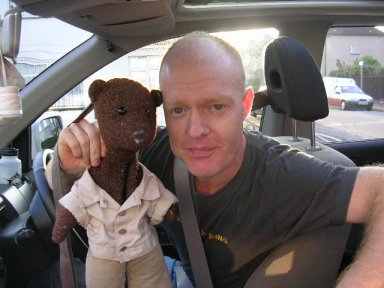 Jake Wood holding Bearsac in car window.