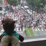Bearsac in foreground of Shibuya crossing during pedestrians turn