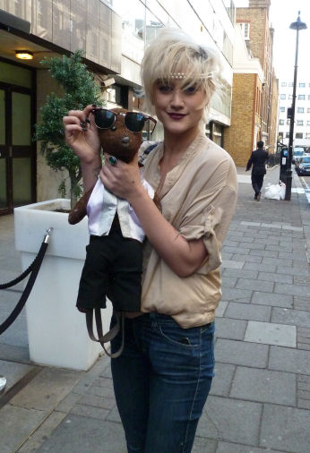 Katie Waissel holding Bearsac, with her sunglasses on his face