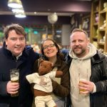 Debra and Bearsac with two men in a pub