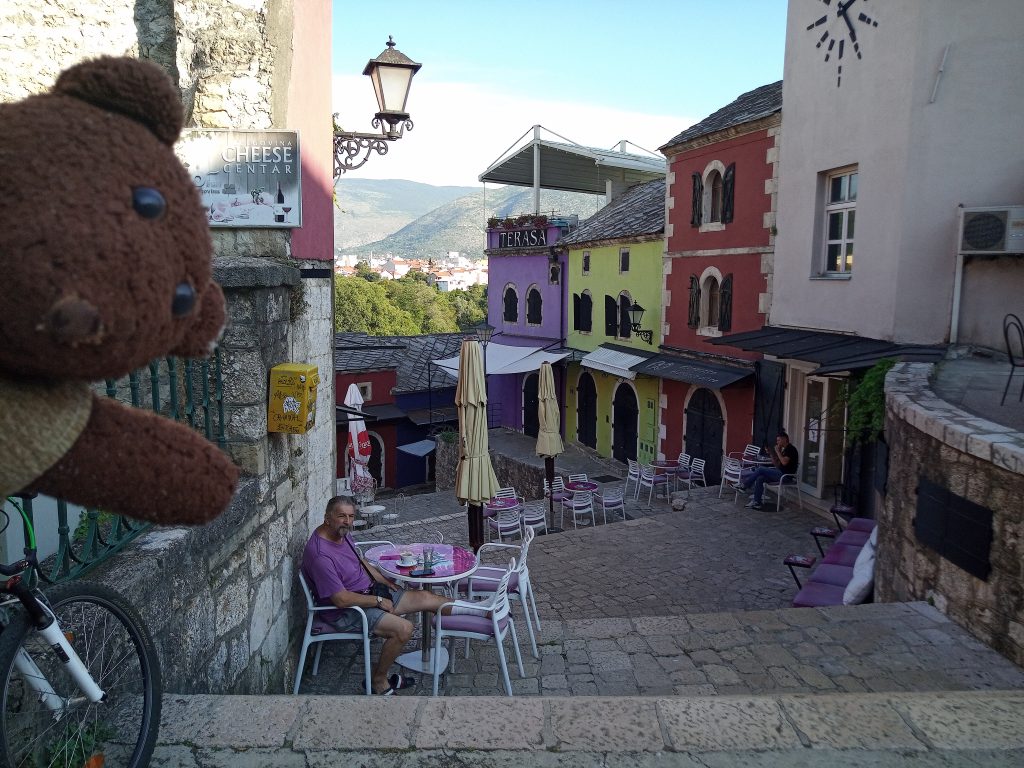 Bearsac at side of a colourful street scene