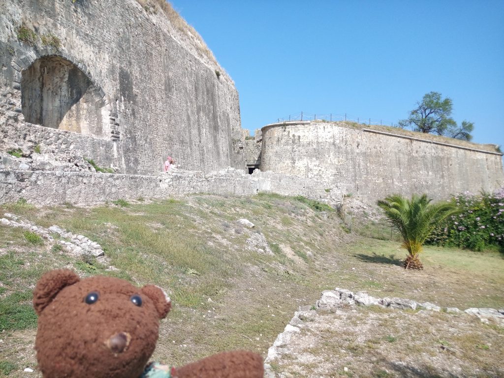 Bearsac in foreground of an old looking new fortress