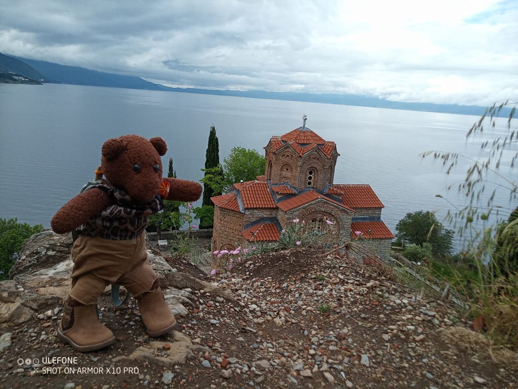 Bearsac in foreground of a church and lake