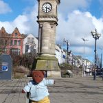 Bearsac the teddy bear in the forground of Bangor Clock Tower
