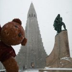 Bearsac the teddy bear in foreground of Evangelical Lutheran Church of Iceland exterior