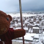 Bearsac the teddy bear in foreground of city view from Evangelical Lutheran Church tower