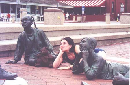 Bearsac and Debra sitting with brass children of the Alex Haley memorial in Annapolis