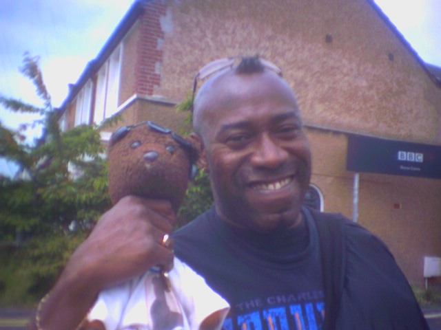 Actor Ulric Browne holding Bearsac around the neck.