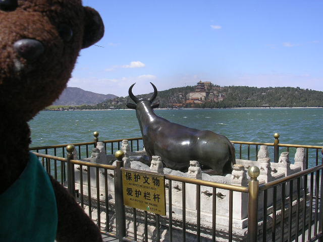 Bearsa beside brass bull beside lake