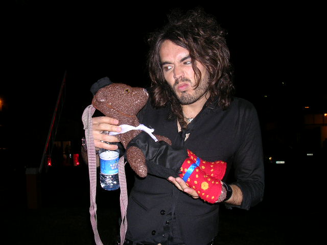 Russell Brand holding Bearsac like a baby