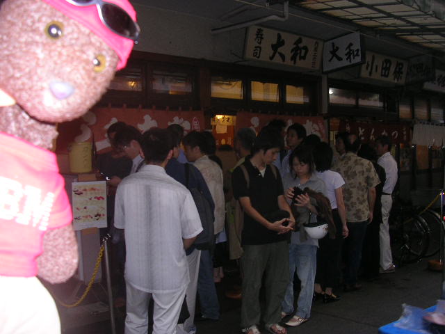 Bearsac by queue of sushi bar.