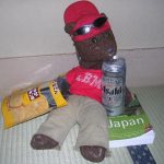 Bearsac on tatami mat with Asahi and Japanese snacks.