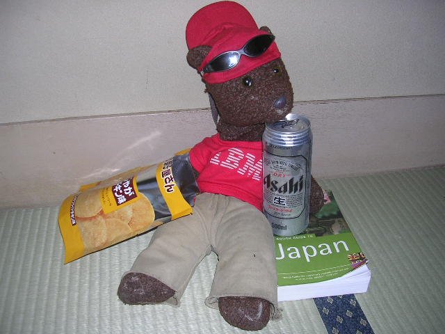 Bearsac on tatami mat with Asahi and Japanese snacks.