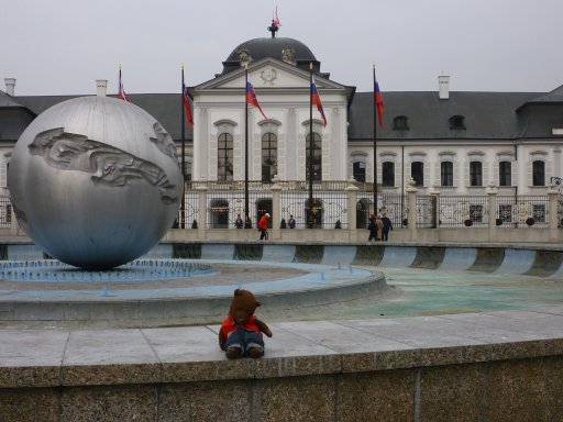 Bearsac sitting on fountain wall outside Grassalkovich Palace
