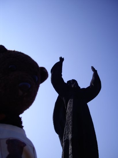 Bearsac beside monument of man with arms raised in Veliko Tarnovo