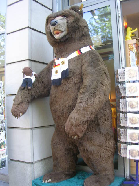 Bearsac sitting on arm of likely 8 foot tall toy bear