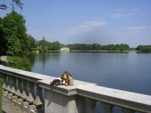 Bearsac on wall in front of lake, with wife and daugther bears