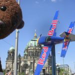 Bearsac beside Red Bull plane