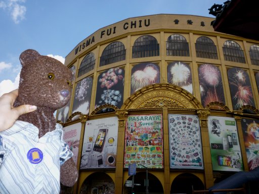 Bearsac outside a dirty shopping arcade.