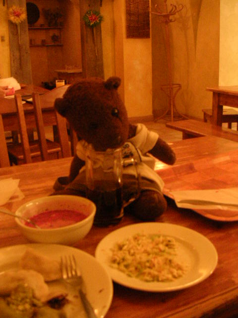 Bearsac sitting on table with Polish food.