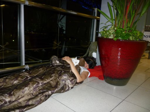 Debra and Bearsac sleeping at Bangkok Int Airport.