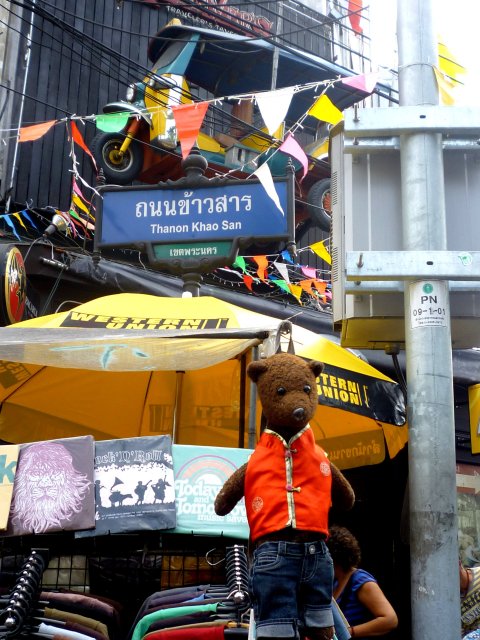 Bearasc hanging on Khao San Road sign.