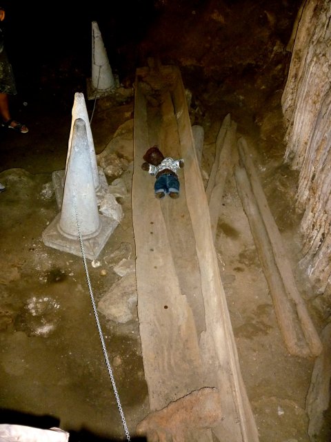 Bearsac sitting in an old coffin in cave