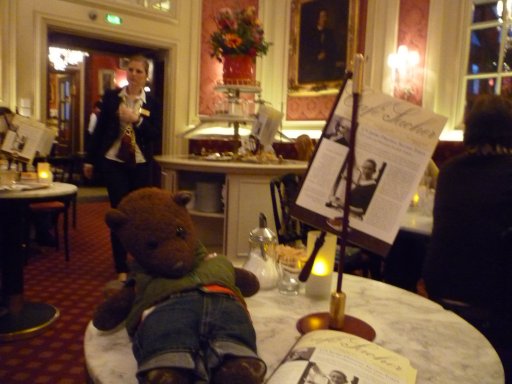 Bearsac sitting on table in luxury hotel cafe.