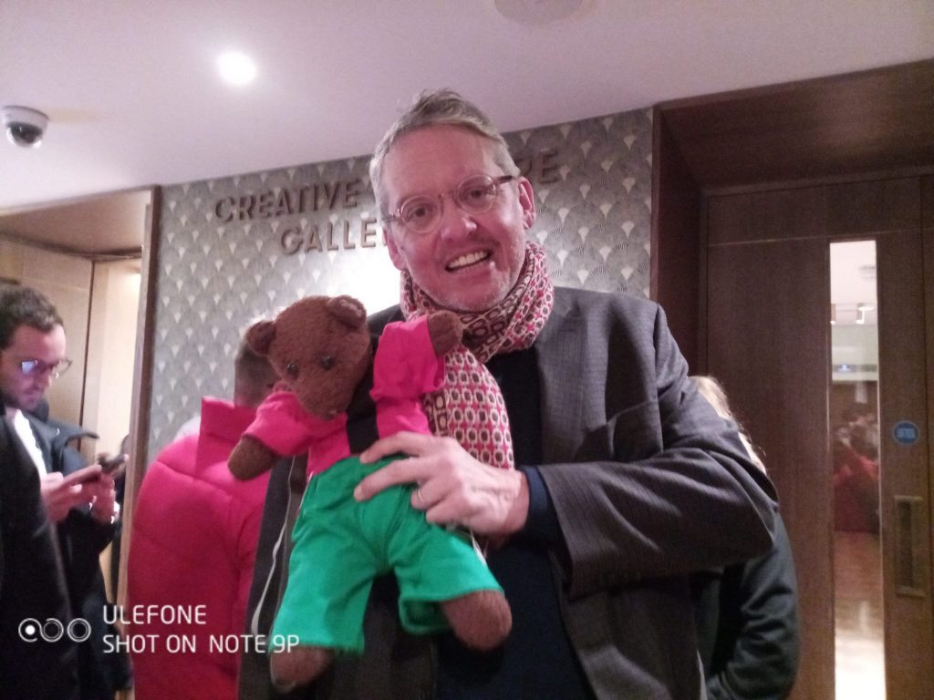 Adam McKay holding Bearsac the teddy bear