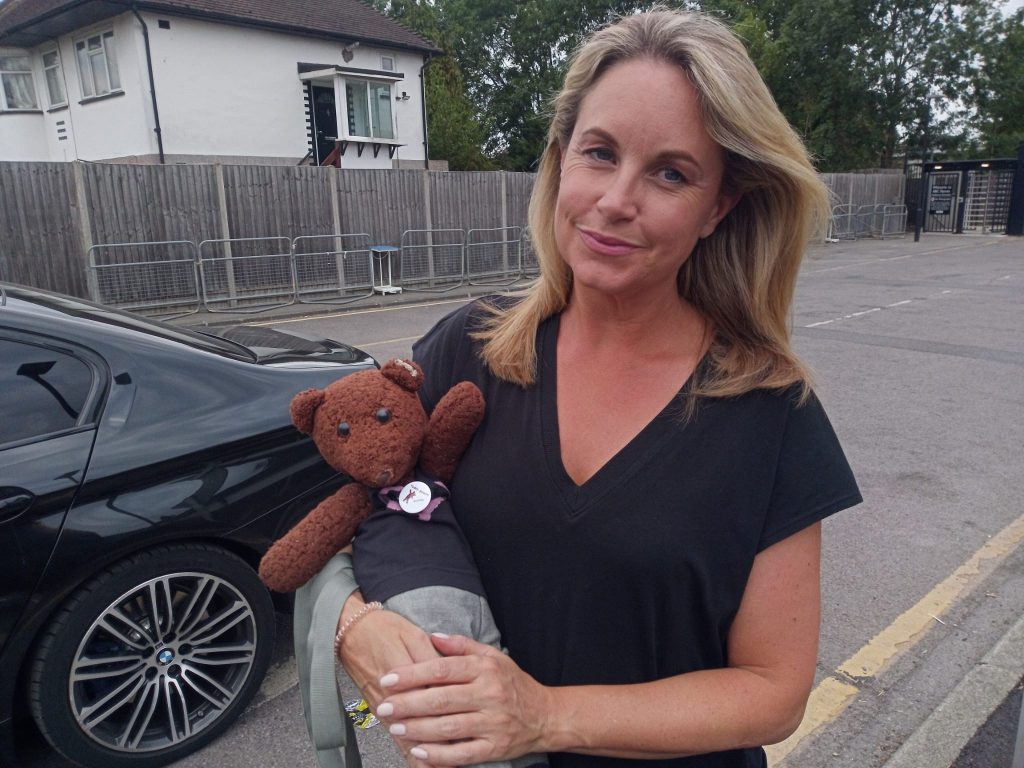 Kim Medcalf holding teddy bear, Bearsac
