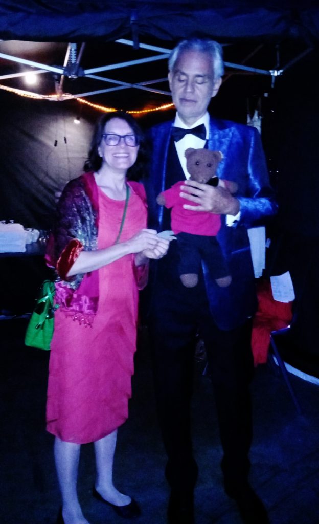 Andrea Bocelli holding Bearsac with Debra standing with him