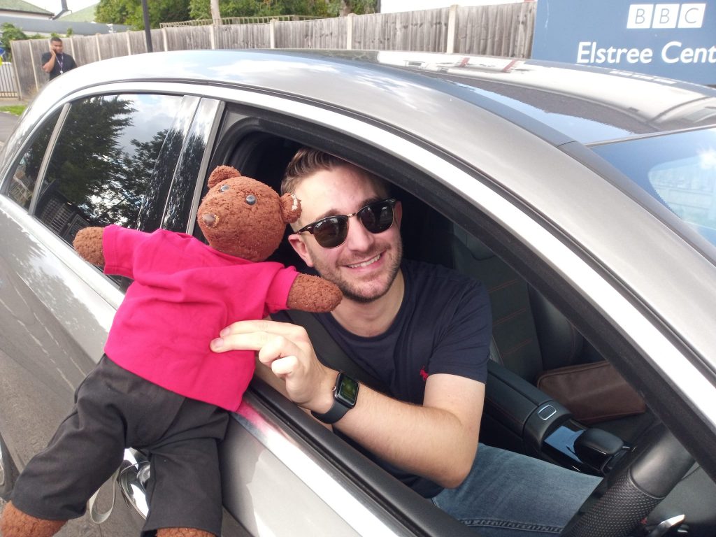 Tony Clay holding Beaarsac out of the window of his car