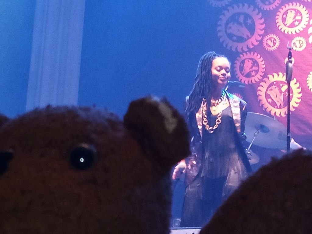 Bearsac'c face in foreground of Angela Ricci