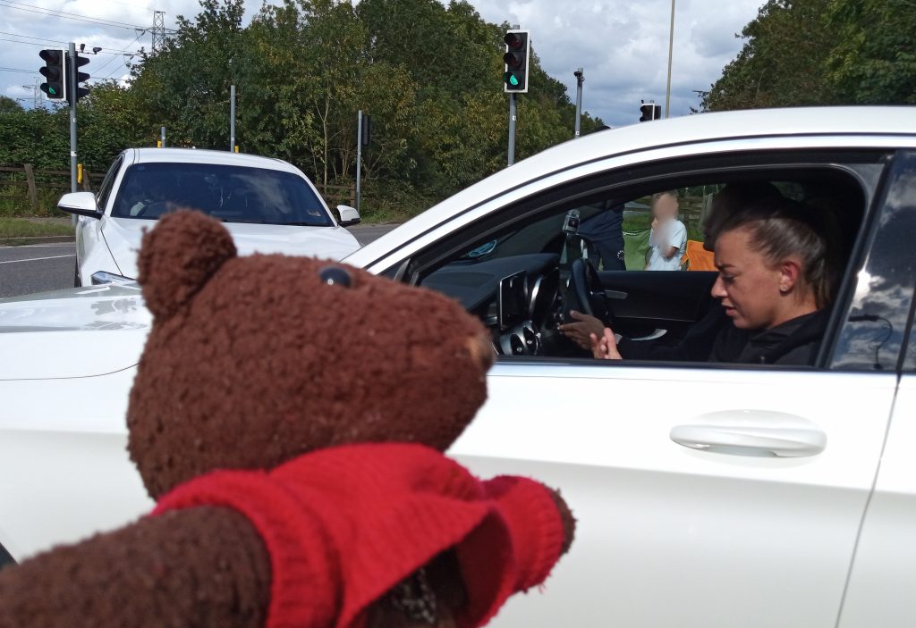 Teddy bear, Bearsac in forground. Katie McCabe in background in car