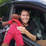 Teddy bear, Bearsac being held by Arsenal WFC player Steph Catley