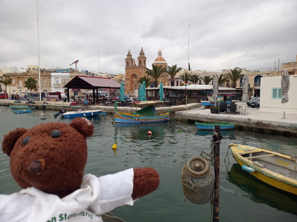 Bearasc in forgrouns of water and boat scene