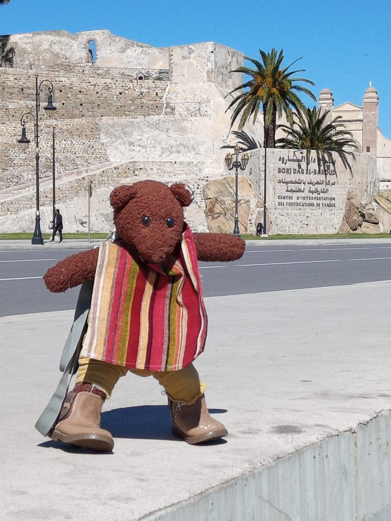 Bearsac the teddy bear in the foreground of Dar Al-Baroud Tower