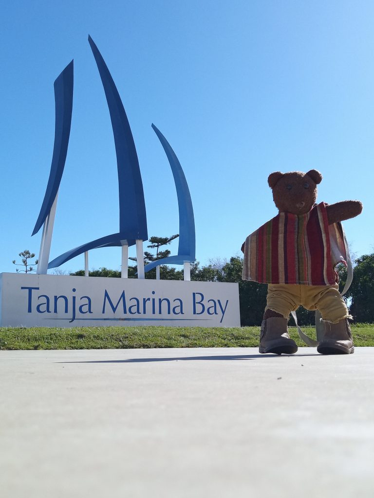 Bearsac the teddy bear in the foreground of Marina Bat sign