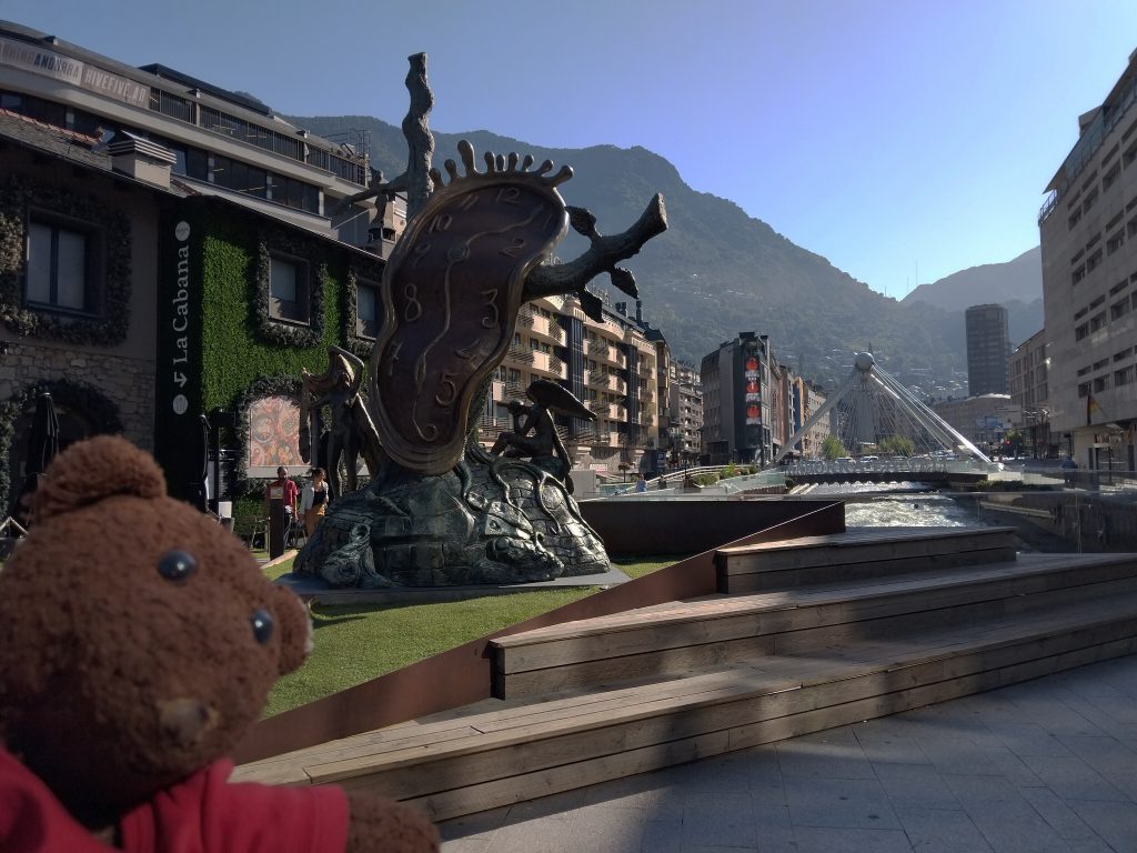 Teddy bear Bearsac in the foreground of the melting clock monument.