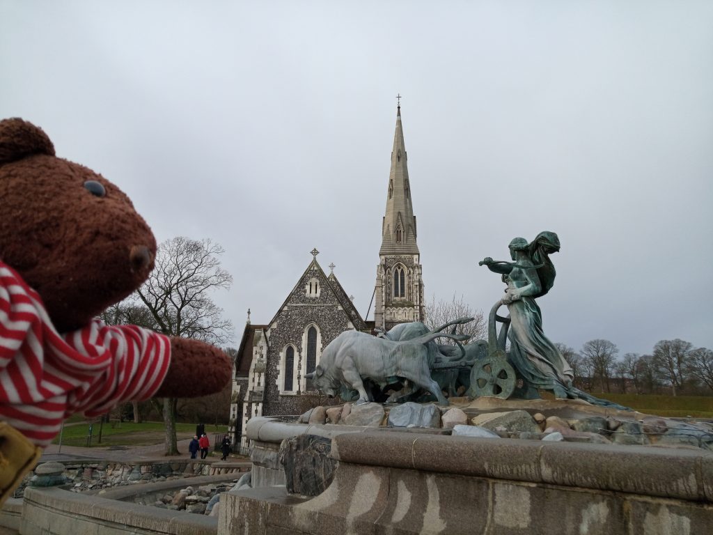 Teddy bear Bearsac in the foreground of St Albans Church
