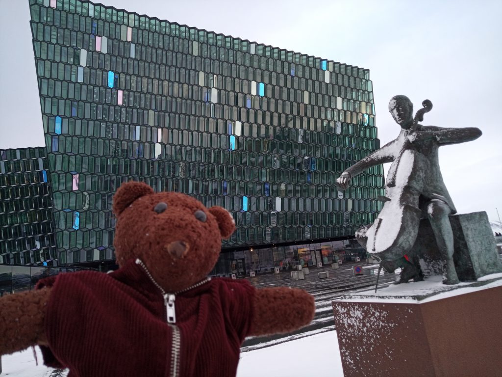Teddy bear Bearsac in forground of Iceland Concert Hall