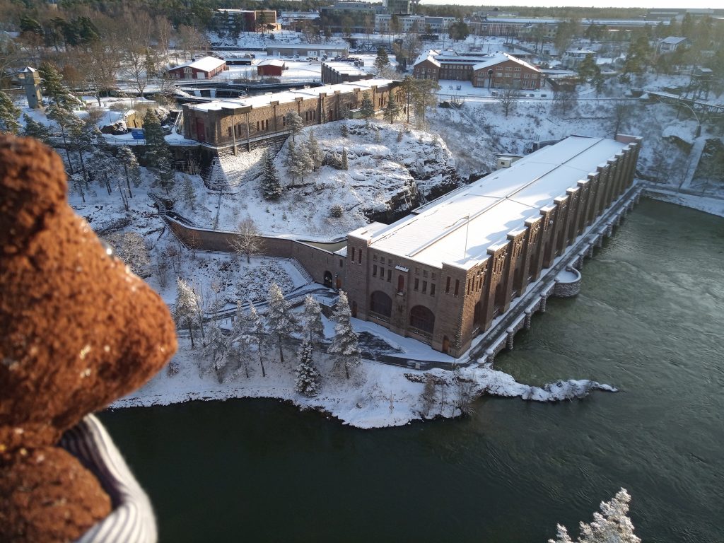 Teddy bear Bearsac overlooking Olidan Hydroelectric Power Station