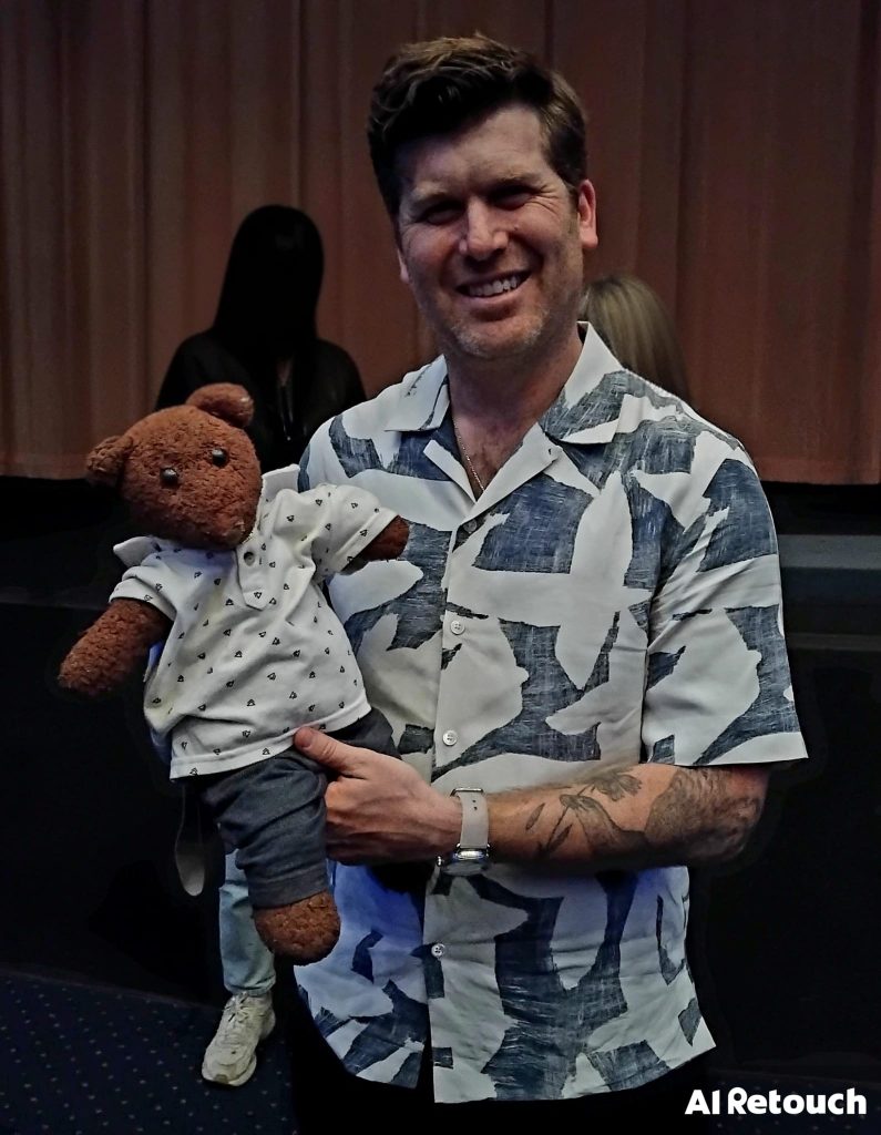 Greg Kwedar holding teddy bear Bearsac