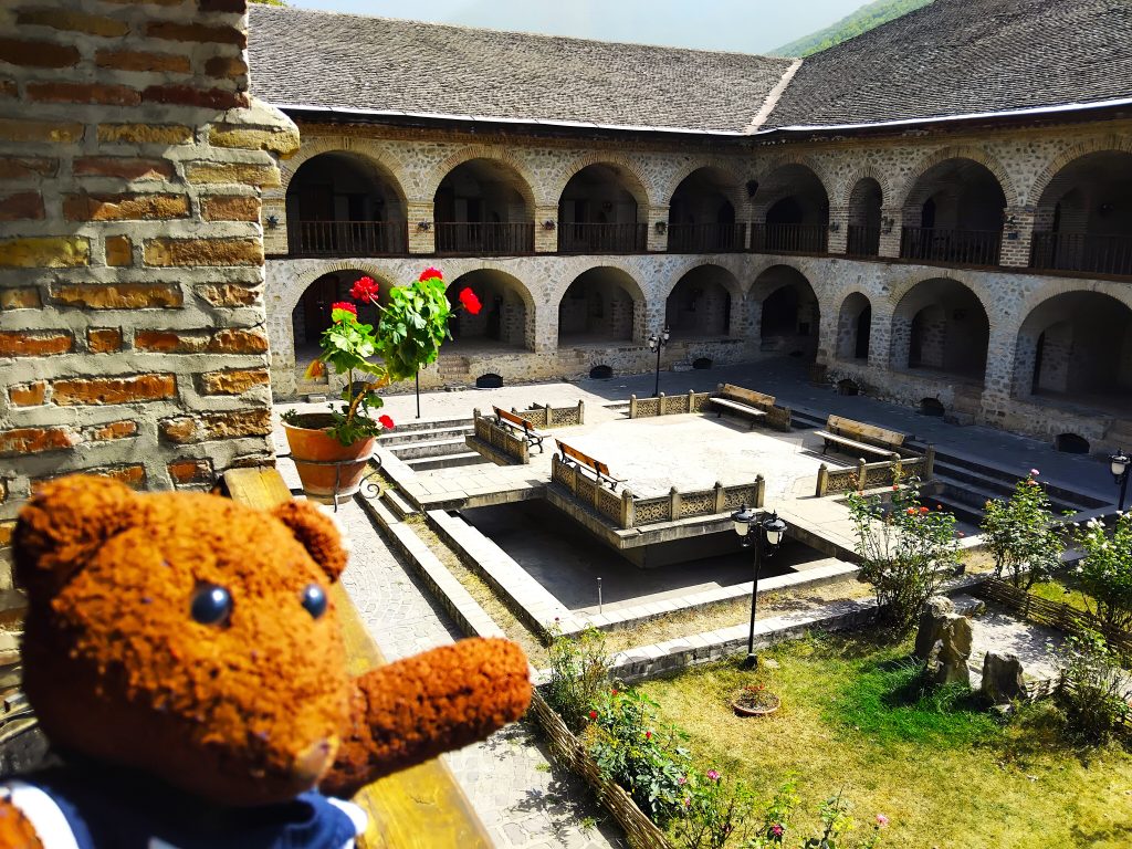 Bearsac the teddy bear in forground of Karavansarai Hotel