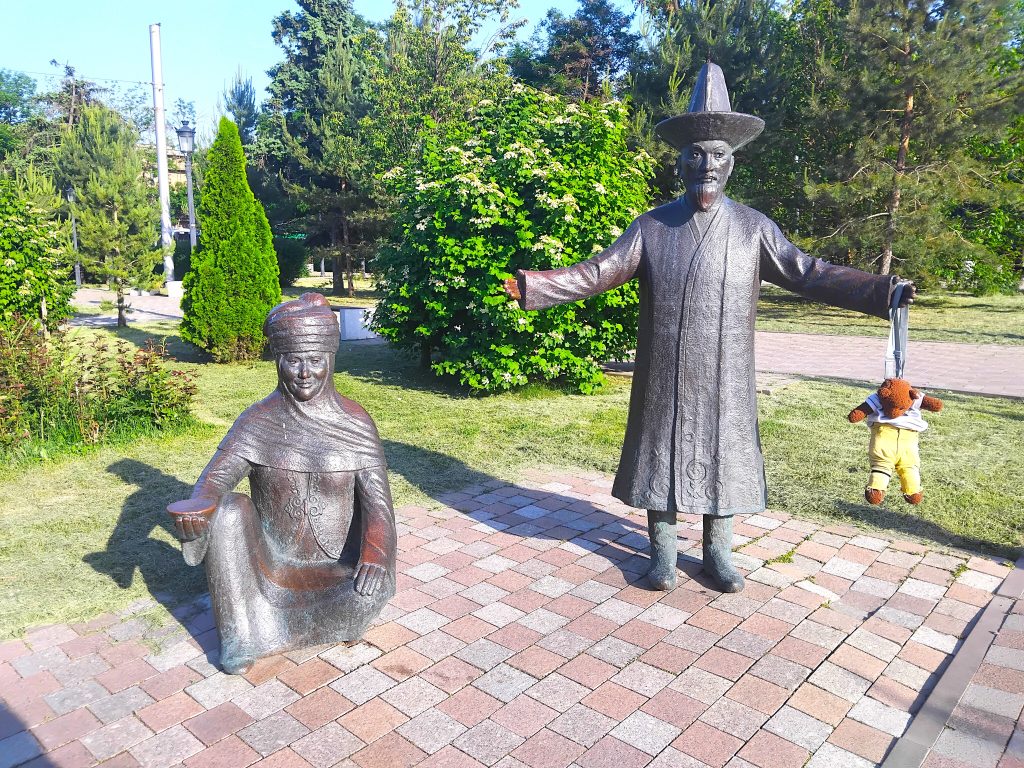 Bearsac the teddy bear hanging on a statue