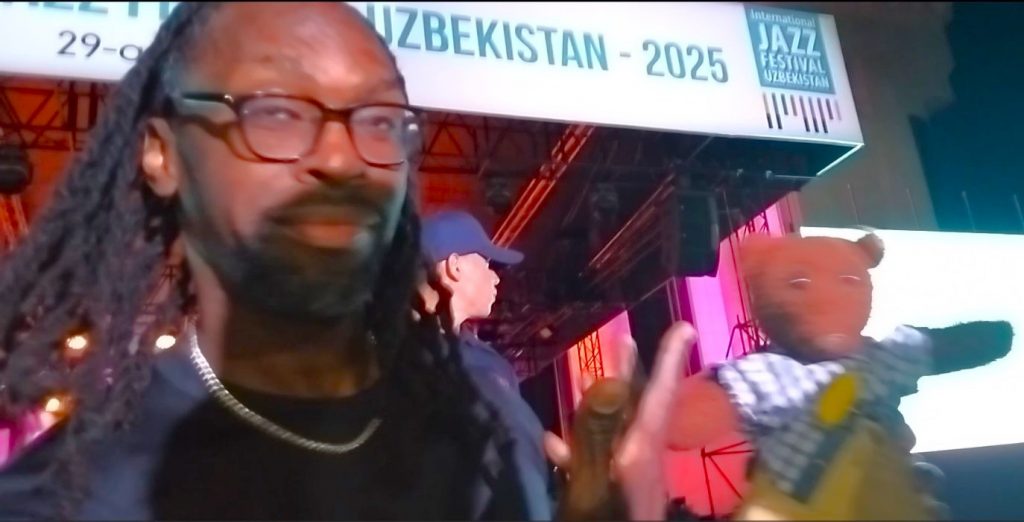 Lee Pearson holding and poiting to Bearsac the teddy bear